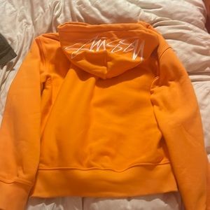 Stussy hoodie hood says stussy orange